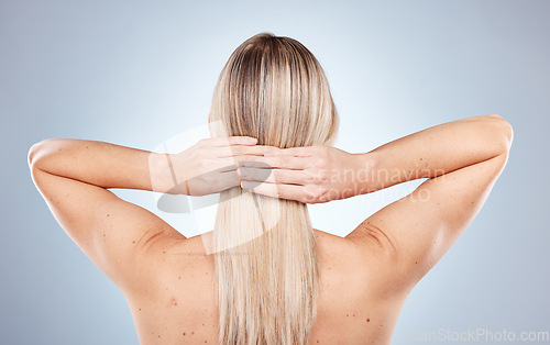 Image of Hair, hands and beauty with a model woman in studio on a gray background for natural haircare or keratin treatment. Salon, wellness and cosmetics with a female posing to promote healthy hair care