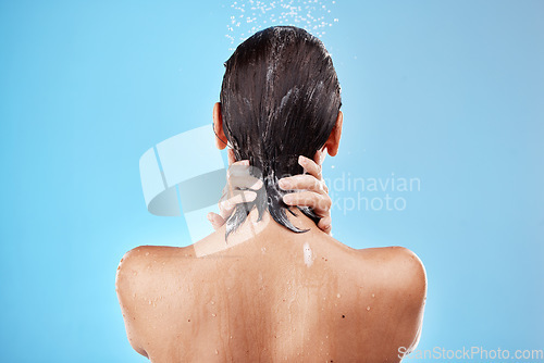 Image of Back, woman and shower for hygiene, bathroom and freshness on blue studio background. Mockup, female and healthy girl with water, clean and wet for wellness, skincare and health with drops and splash