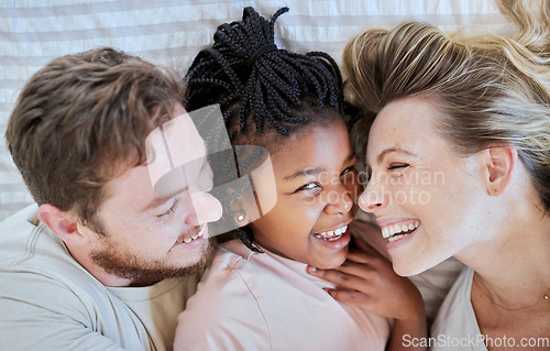 Image of Family, love and bed fun of a mom, dad and adopted girl laughing with a funny time at home. Portrait of a interracial child with mama and father smile bonding with parent care in a house bedroom