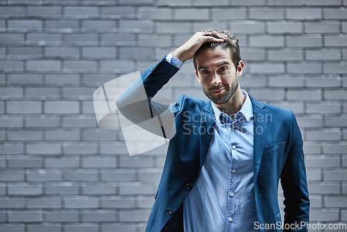 Image of Fashion, mockup and suit with a business man or model standing outdoor in the city on a brick wall background. Portrait, style and mock up with a handsome male employee posing in an urban town