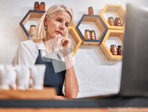 Image of Stress, laptop and honey store owner with anxiety, business fail and loss from inflation, depression and worry. Senior woman, small business and issue at startup organic shop search online solution