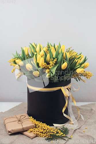 Image of Bright spring bouquet of tulips and mimosa flowers