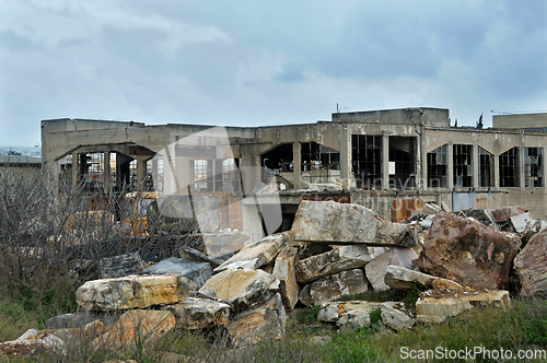 Image of abandoned factory exterior and cloudy sky