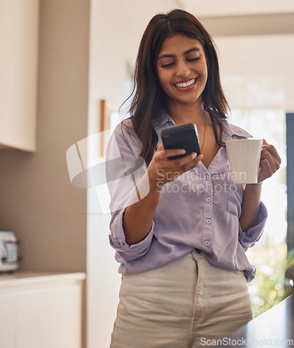 Image of Woman, phone and smile with coffee for communication, chatting or social media in the kitchen at home. Happy female smiling and enjoying drink while texting on mobile smartphone app in conversation