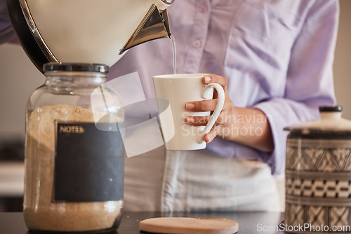 Image of Water, drink and woman make coffee in kitchen for motivation, energy and caffeine in morning. Lifestyle, cafe and closeup of hands pouring water from kettle to mug for hot beverage, espresso and tea