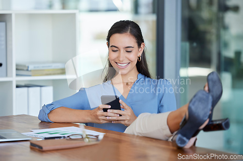 Image of Smile office and phone, typing with feet up on desk, relax while surfing internet or social media with smile on face. Communication, smartphone and happy businesswoman ceo writing text while on break