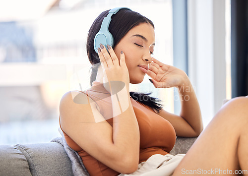 Image of Headphones, music and woman on sofa listening to podcast streaming service with student discount subscription for mental health wellness. Relax, calm and peace of young gen z girl on audio sound tech