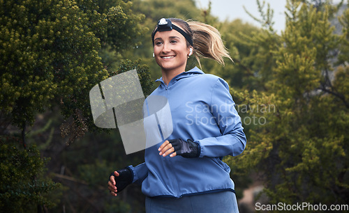 Image of Fitness, nature and woman running on a trail for cardio workout in the woods or green garden. Health, wellness and young woman from Canada training for sports marathon, race or competition in forest.