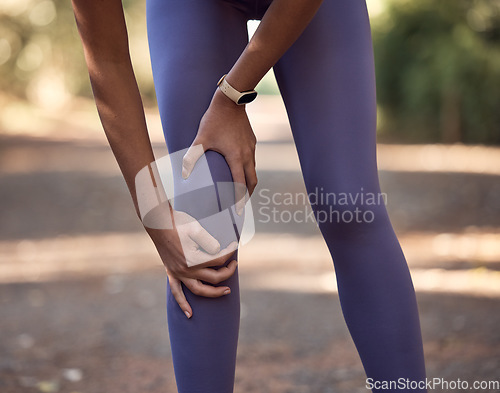 Image of Knee pain, injury and accident of a woman training for a running marathon, race or competition in nature. Sprain bone, injured leg and swollen muscle of athlete doing cardio exercise on outdoor trail