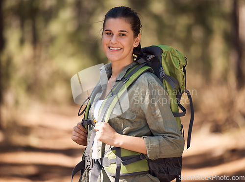 Image of Hiking, backpack and woman in forest portrait for journey, travel and adventure in nature with sports, fitness and wellness gear. Woods, trees and nature athlete smile, walking or trekking outdoor