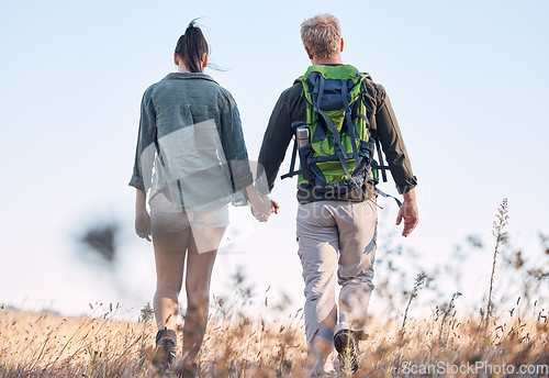 Image of Couple, holding hands and travel or backpack adventure in bonding relationship together in the countryside. Hands of man and woman backpacking, trekking or walking in care or support for traveling