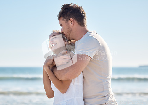 Image of Beach, blue sky and love couple hug, relax and enjoy ocean freedom, peace or fun time on outdoor adventure date. Nature sea, happy marriage bond and romantic man and woman on travel in Toronto Canada