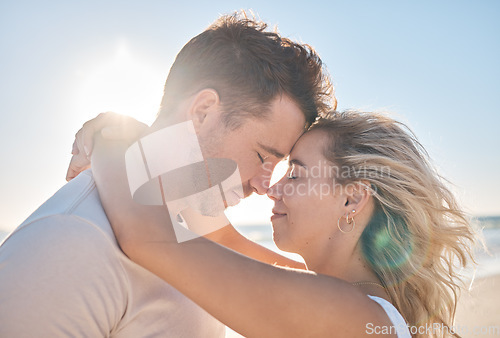 Image of Beach hug, couple love and forehead touching of husband and wife on honeymoon vacation in Toronto Canada. Blue sky flare, freedom peace and marriage partnership bond of man and woman on romantic date