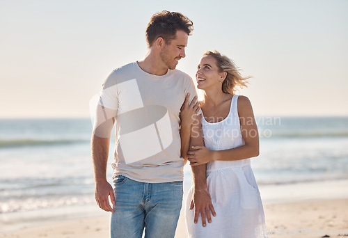 Image of Travel, love and couple at the beach at sunset, walking and relax along the ocean, bond and happy together. Freedom, woman and man walk at a sea, smile and enjoy relationship, holiday and Cancun trip