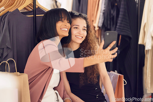 Image of Women, friends and phone selfie while shopping in store for luxury and designer clothing. Retail, fashion sales and people take picture with mobile smartphone for social media or happy memory in mall