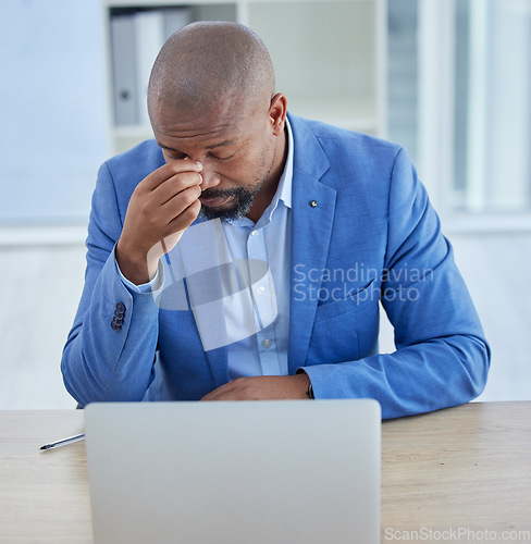 Image of Businessman, laptop and headache in burnout, stress or depression from overworking at the office. Black man employee suffering in mental health problems or strained eyes from long hours on computer