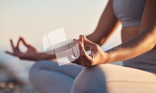 Image of Woman, hands or lotus pose meditation on sunset beach, ocean or sea in mental health, mind training or chakra balance. Zoom, peace or zen yogi in calm mudra, relax yoga wellness or sunrise gratitude