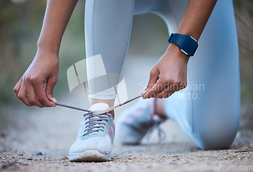 Image of Fitness, exercise and woman tie shoe after running, workout and marathon training in nature. Sports, wellness and closeup of hands tying lace on sneakers for performance, run and exercising outdoors