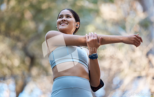 Image of Fitness, healthcare and woman stretching arm getting ready for training, exercise or workout. Sports, wellness and happy female runner warm up alone outdoors preparing for running, jog or marathon.