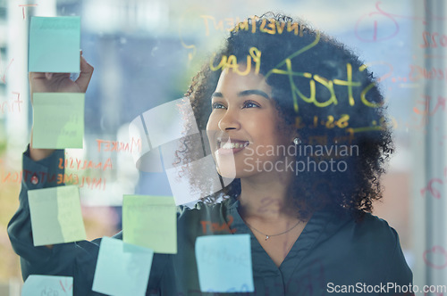 Image of Business woman, planning and writing with sticky note, glass and strategy for marketing research in advertising company. Corporate worker, happy and innovation plan, analytics and company vision