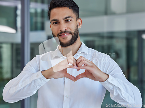 Image of Business man, heart emoji and smile of CEO, boss or leader for charity, support and thank you sign in office with happiness and pride. Portrait of entrepreneur happy about growth, trust and kindness