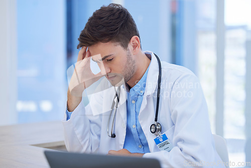 Image of Man, doctor or stress headache in hospital data analysis, test results analytics or surgery planning. Thinking healthcare worker, anxiety or mental health burnout on medical clinic laptop technology