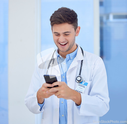 Image of Doctor, man and phone with smile for texting, communication or chatting and good connection at hospital. Happy male healthcare or medical professional smiling for telecommunication service at clinic