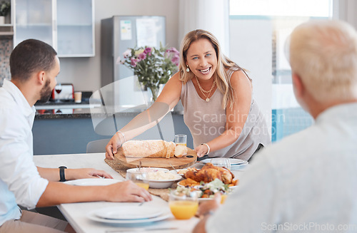 Image of Lunch, celebration and happy family with food at a dining room table on holiday at the accommodation. Serving, dinner and senior woman with bread and chicken for hungry people in family home