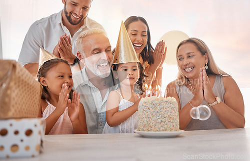 Image of Family, birthday party and cake with celebration, clapping and singing with candle or gift on table in home. Girl, parents and grandparents with sister celebrate event in house with birthday cake