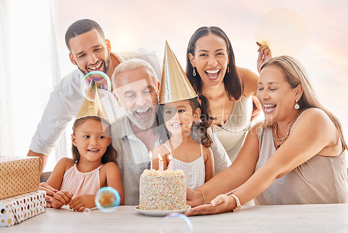 Image of Birthday, party and family with a girl, parents and grandparents in celebration together in their home. Cake, hat and gift with children celebrating a milestone during a happy event in a house