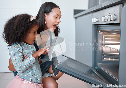 Image of Kitchen, mom and girl excited with baking in oven, checking results, working together and learning to bake family recipe. Child development, happy home cooking and bonding time for woman and child