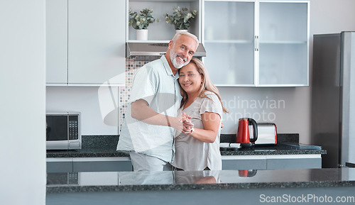 Image of Love, marriage and dance with a senior couple in the kitchen of their home together for bonding or romance. Portrait, happy and smile with a mature man and woman romantic dancing in their house