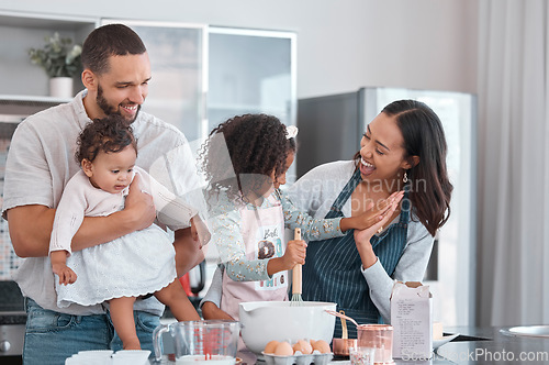 Image of Family, baking and cooking together with high five in home kitchen with children learning from mother and father to cook food, breakfast and pancakes or cake. Man, woman and kids helping make cookies