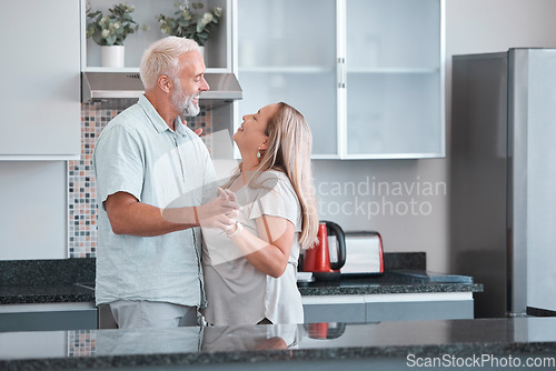 Image of Love, dance and a senior couple in kitchen of home together enjoying weekend time and celebrate life with smile. Retirement, happiness and health, a happy man and woman dancing in house or apartment.