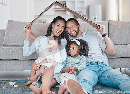 Image of Happy family, new house and cardboard roof in living room, mortgage loan and investment security for future. Real estate, insurance and property cover for new homeowners, excited parents and children