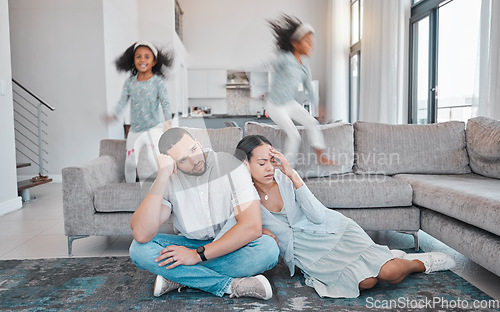 Image of Tired, parents and children jump on sofa with frustrated mom and dad sitting on floor in living room. Family, exhausted couple and playful kids with energy jumping on couch at home during quarantine