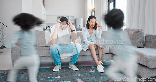 Image of Mother, father and stress in burnout with child busy running around in the living room annoying parents on sofa at home. Tired mom and dad suffering in depression, anxiety or headache from noisy kids