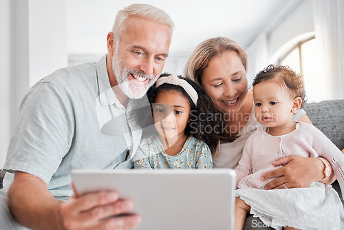 Image of Tablet, grandparents and children on sofa streaming video or movie online in living room. Senior man, happy kids and elearning or relax family game on digital tech device on couch at family home