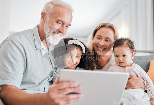 Image of Family, tablet and online browsing with senior people babysitting grandchildren in the family home. Grandfather, grandmother and grandkids with a digital tablet for streaming internet media