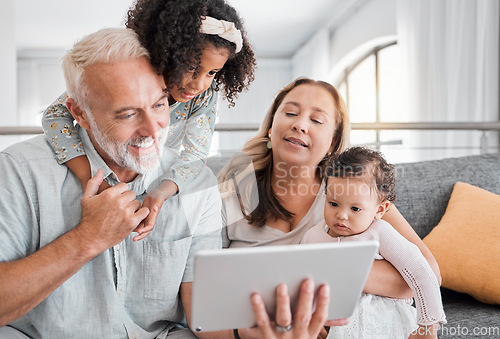 Image of Relax, tablet and grandparents with children on sofa for movie, cartoon or educational app online. Grandmother, grandpa and kids streaming entertainment in interracial family home in Mexico.