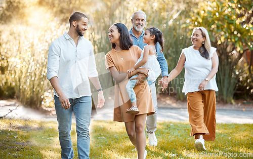 Image of Big family, walking in a nature park and happy smile with black people walking on grass in summer sunshine for bonding, love and quality time together. Grandparents, father with mother and daughter