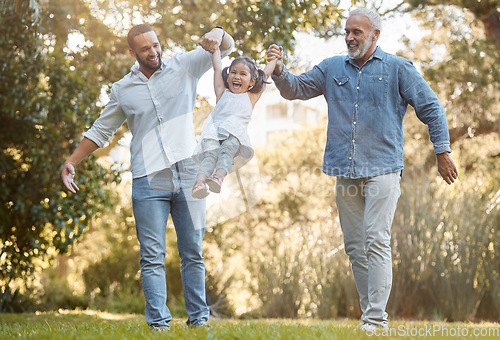 Image of Diverse, family and playing in a park for fun, bonding and love in summer with a father, grandfather and daughter. Garden, big family and interracial family swinging little girl play with joy