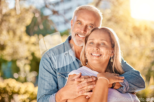 Image of Mature couple, hug and bonding in nature park, environment garden or backyard for interracial marriage anniversary, love or trust. Portrait, smile or happy man and middle aged woman in retirement