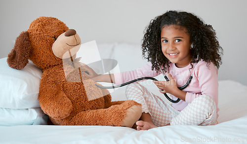 Image of Learning, teddy bear and girl playing with stethoscope, having fun or acting like doctor in bedroom. Portrait, education and child test, check or listening to heartbeat of stuffed animal or baby toy.