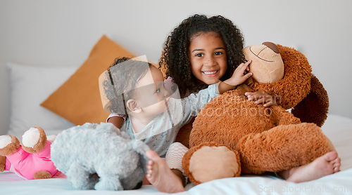 Image of Children, baby girl and siblings bonding with teddy bear on house, family home or orphanage bed and support, security or comfort trust toy. Smile, happy and playful kids with stuffed animal in foster