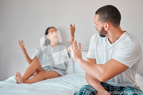 Image of Argument, stress and couple fighting in bed for breakup, divorce or toxic relationship at home. Break up, angry and upset man and woman arguing in bedroom for cheating, affair or financial difficulty