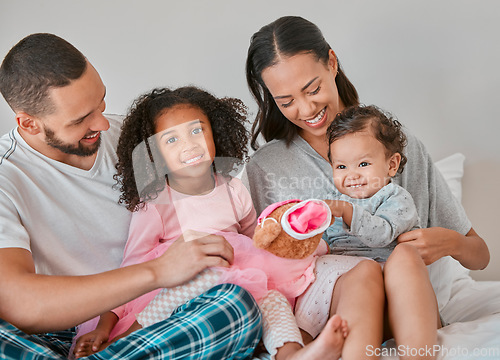 Image of Happy family, love and bedroom with child, baby and parents together on a bed for care, bonding and quality time at home. Portrait of kids, man and woman in Puerto Rico house to relax and connect