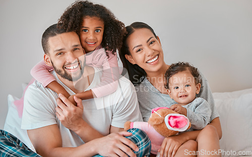 Image of Bonding, care and smile from family in the bedroom with love, peace and relax together in the morning. Happy, affection and portrait of a mother and father with their girl children in bed for rest