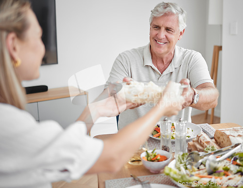 Image of Thanksgiving, dinner and family pass food at table enjoying festive celebration together at home. Love, family home and grandfather giving dish to woman at lunch, supper and meal in dining room
