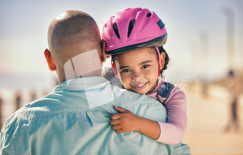 Image of Father, bicycle and girl portrait of a young kid with a helmet by the sea ready for cycling learning. Family, holiday and fun of a dad and child hug with happiness and bike gear excited for activity